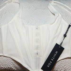 Brand new. Never worn. Boning. Corset top. Zipper back.